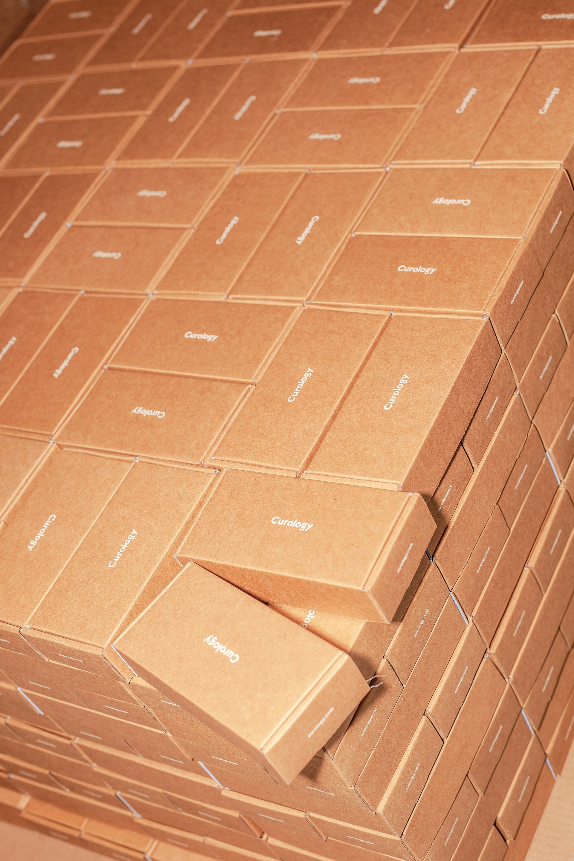 Stacked brown cardboard boxes with branding